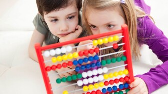 brother and sister playing with abacus