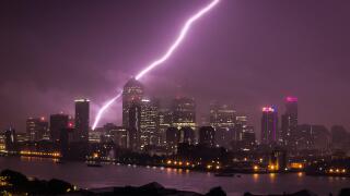 Massive Lightning strike just behind Canary Wharf business park buildings and River Thames in London, UK.
