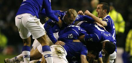 Everton players pile on top of goalscorer Dan Gosling after he scores his sides first goal of the game