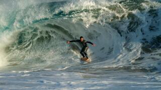Surfers riding the huge surf created by Hurricane Marie in the Pacific Ocean at the Wedge in Newport Beach Southern California