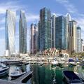 Dubai Marina skyline cityscape with yachts skyscraper real estate buildings living at water panorama boats