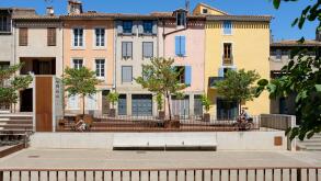 Colourful French houses beside the Cathedral Saint - Michel in Carcassonne, France.