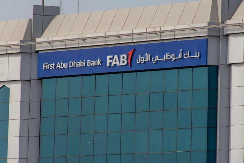 "Ras al Khaimah, Ras al Khaimah/United Arab Emirates - 7/4/2019: "First Abu Dhabi (FAB) Bank blue storefront on a blue sky sunny day. "