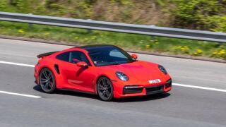 2021 red Porsche 911 TURBO S-A S PDK 3745cc petrol coupe; driving on the M61 motorway in Manchester, UK