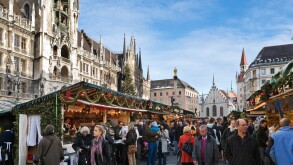 Christmas Market in Marienplatz with the New Town Hall to the left and the Old Town Hall behind, Munich, Germany