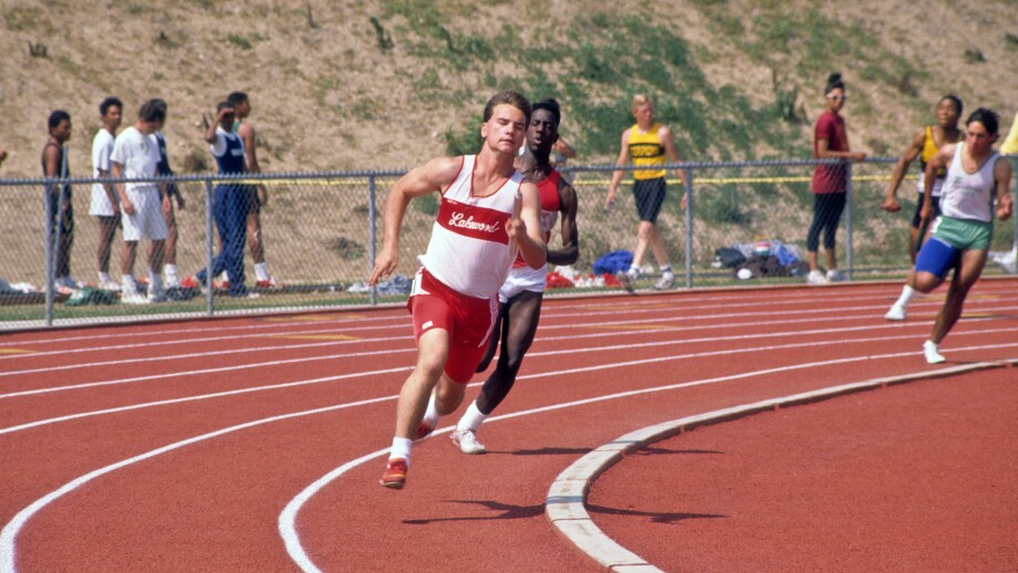 High school athletes take the curve of the track during race at track meet. Image shot 2004. Exact date unknown.