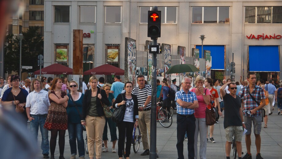 People at pedestrian crossing waiting for the green light. Berlin, Germany.