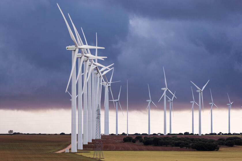 Iberdrola Wind Turbine - Eolic Generator with stormy clouds in Sisante, Cuenca province, Castilla, Spain