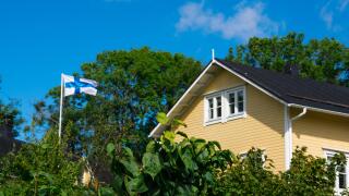 Helsinki, Finland. August 26, 2017. Yellow house and Flag of Finland in Suomenlinna (Sveaborg) Fortress