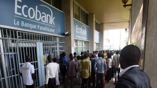 Customers crowd the entrance to a branch of Ecobank in the Plateau business district of Abidjan, Ivory Coast Wednesday, Feb. 16, 2011. Another bank says it has closed its doors amid a political crisis in Ivory Coast, as residents in the commercial hub lin