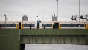 passengers getting off South Eastern train on Cannon Street  rail bridge, with Tower Bridge in background