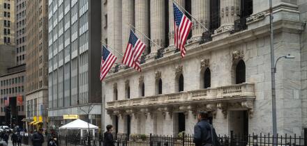 People walk past the New York Stock Exchange (NYSE) on Wall Street on March 4, 2026 in New York.