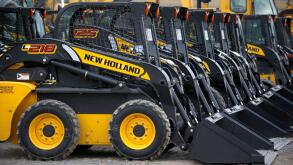 FILE - In this photo made on Friday, March 28, 2014, earth moving and construction equipment by New Holland, a CNH Industrial brand, is stored on a lot at the Highway Equipment Company in Zelienople, Pa. More than 1,000 workers at CNH Industrial plants in