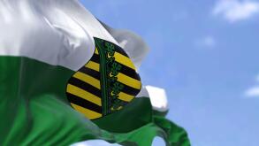 The flag of Saxony waving in the wind on a clear day