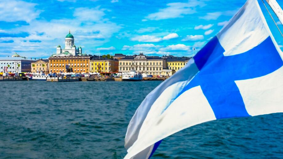 Helsinki skyline from the sea.The Finnish flag is floating. Market Square and Helsinki Cathedral from the sea. The seascape of Helsinki in the summer.