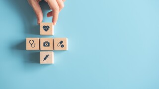 Health Insurance Concept, Hand of woman arranging wood cube stac