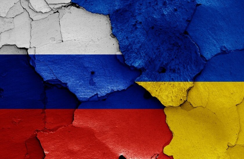 flags of Russia and Ukraine painted on cracked wall