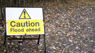 Flood ahead caution warning road sign water risk for drivers