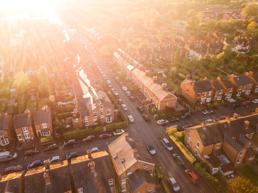 Sun setting over a traditional British neighbourhood. Lens flare