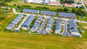 Aerial view of residential houses and driveways neighborhood. Tightly packed homes, surrounds with green tree flyover Europe. Suburban housing communi