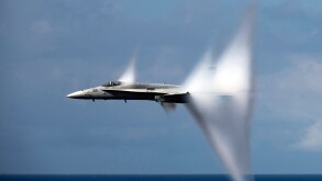 F/A-18C Hornet Jet airplane breaking the sound barrier.