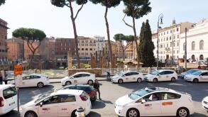 Taxi cars parked in street in Rome, Italy