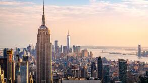 The New York City skyline including the Empire State Building, One World Trade Center and the Hudson River, USA.