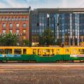 Tram departs from a stop on street Aleksanterinkatu in Helsinki