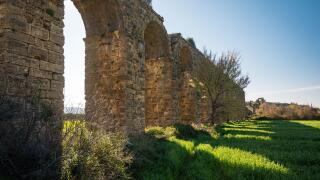 Ancient Roman aqueduct ruins of Aspendos in green spring landscape