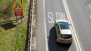 Car braking at warning to slow down on UK road