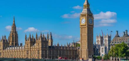 View of Houses of Parliament and Westminster Bridge from Queens Walk during summer in Westminster London England