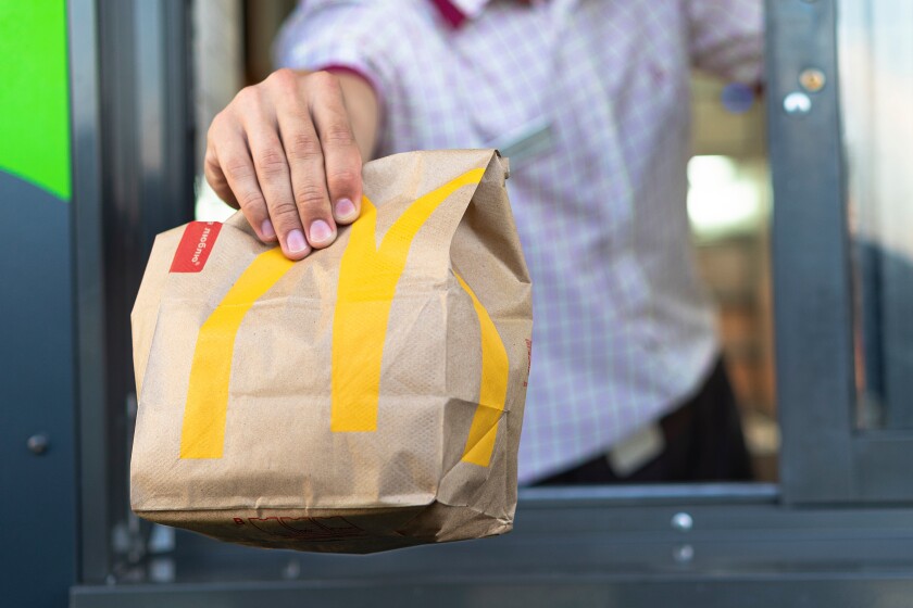 Sankt-Petersburg/Russia - July 21 2019: McDonald's worker holdin