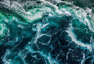 Abstract background. Waves of water of the river and the sea mee