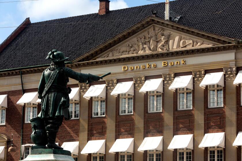 COPENHAGEN, DENMARK - SEPTEMBER 08, 2018:  Danish 17 century war hero Niels Juel points at Danske Bank?s headquarter at Holmen?s Kanal in Copenhagen. Danske Bank is the largest bank in Denmark. According to a Wall Street Journal article on September 07, 2