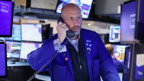 A trader works on the trading floor at the New York Stock Exchange (NYSE) in Manhattan, New York City, U.S., May 5, 2022. REUTERS/Andrew Kelly