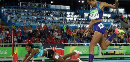 FILE - In this Aug. 15, 2016, file photo, Bahamas' Shaunae Miller-Uibo falls over the finish line to win gold ahead of United States' Allyson Felix, right, in the women's 400-meter final during the athletics competitions of the 2016 Summer Olympics at the