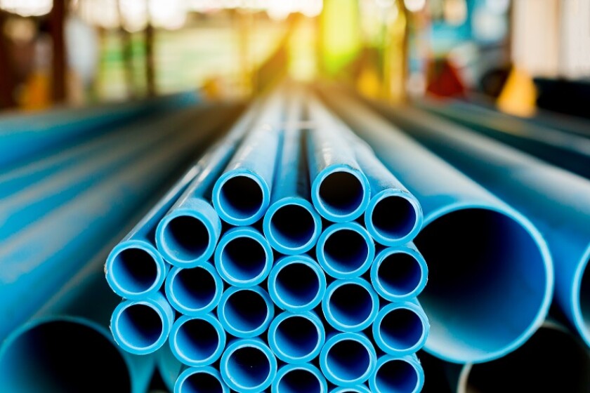 Close up to blue plastic pipe background, PVC pipes stacked in warehouse, PVC water pipes used for construction