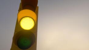 Outdoor vertical traffic light. Traffic control concept image with shallow depth of field.