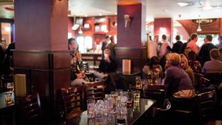 A table full of empty glasses in a pub on a weekend night in Cardiff, Wales, UK