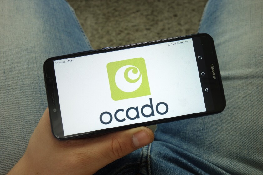 KONSKIE, POLAND - April 13, 2019: Man holding smartphone with Ocado Group plc logo