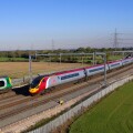 A Virgin Pendolino heads a Glasgow bound service north through Litchfield Trent Vallet while a London Midland stopper heads sout