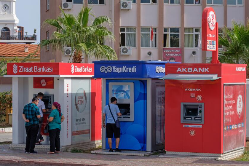 People using Ziraat Bankasi, YapiKredi and Akbank ATM machines in Kemer, Turkey