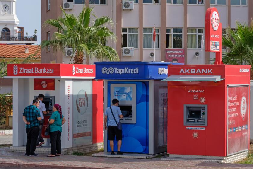 People using Ziraat Bankasi, YapiKredi and Akbank ATM machines in Kemer, Turkey