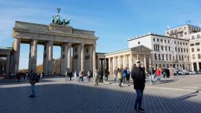 People walk near the Brandenburg Gate in Berlin, Germany, Wednesday, Nov. 5, 2025. (AP Photo/Steve Luciano)