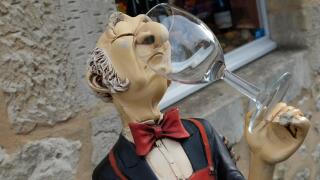 snooty french wine waiter holding glass