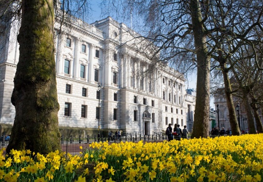 HM Treasury building with daffodils in St James's Park in foreground in spring springtime Westminster London England UK