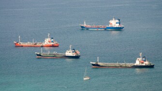 Cargo ships at anchor in front of Gibraltar