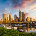 Golden sunrise view of the skyline of Frankfurt am Main, Germany, with banking skyscrapers, Eiserner Steg Bridge and River
