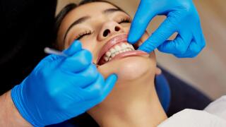 Get the smile you deserve. a young woman having a dental procedure performed on her.