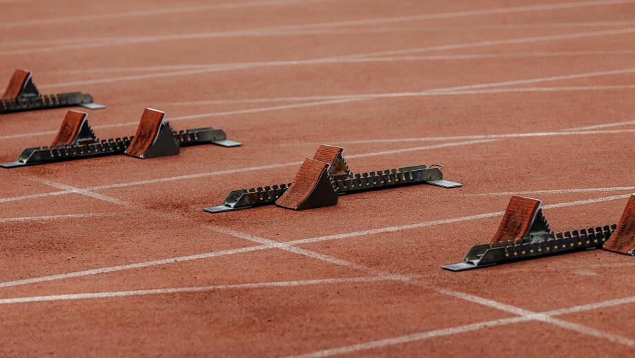 starting blocks on start line of running track stadium